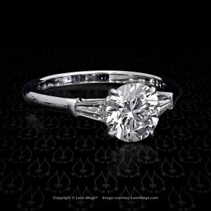 Custom made three stones ring featuring a round brilliant by Leon Mege.