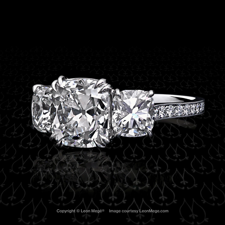 Three stones ring featuring a True Antique cushion diamond by Leon Mege.