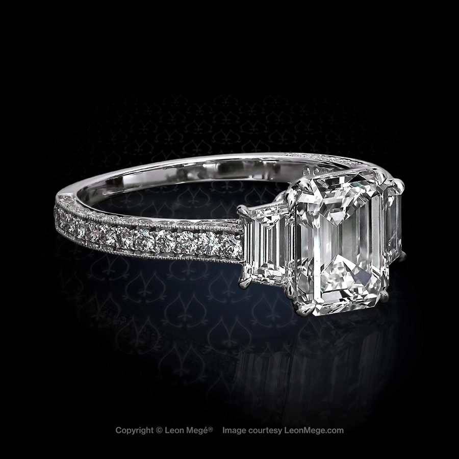 Three stone engagement ring featuring an emerald cut diamond by Leon Mege.