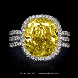 Custom made halo ring featuring a cushion cut fancy yellow diamond by Leon Mege.