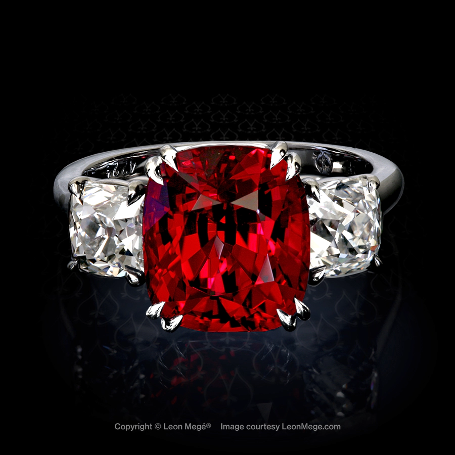 Classic three-stone ring featuring a red spinel with True Antique cushion diamond by Leon Mege.