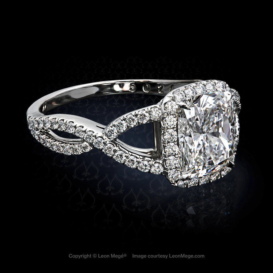 Custom halo engagement ring featuring a cushion diamond by Leon Mege