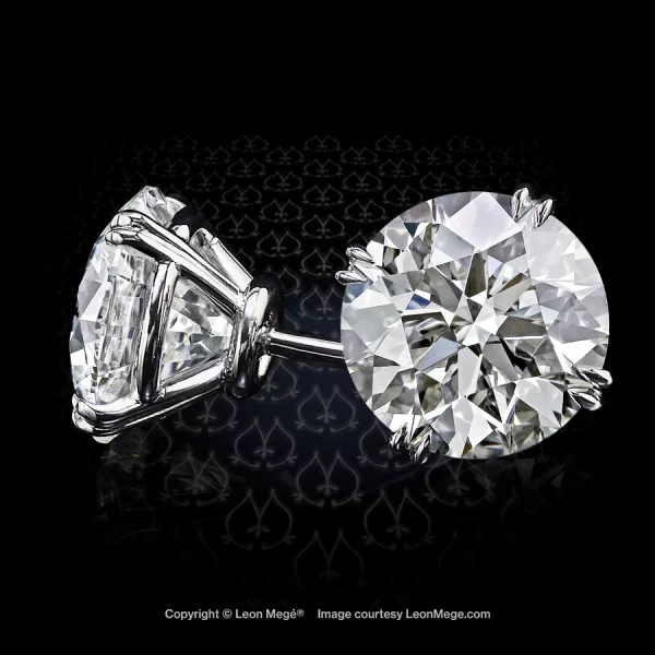 Round diamond studs with double claw prongs by Leon Mege.