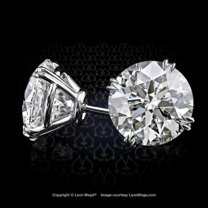 Round diamond studs with double claw prongs by Leon Mege.