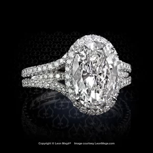 Custom halo engagement ring featuring an oval diamond by Leon Mege.