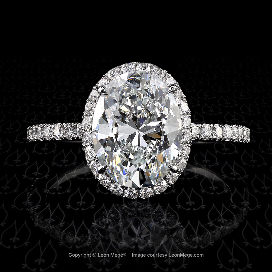 Halo engagement ring featuring an oval diamond by Leon Mege.