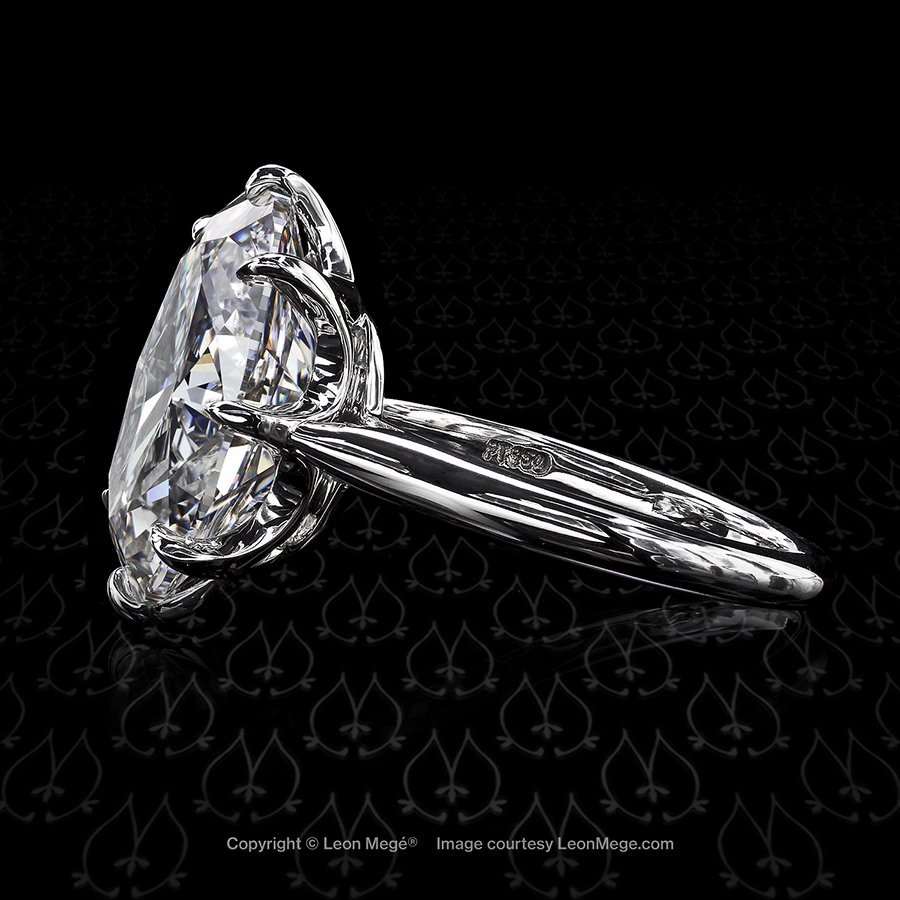 Custom solitaire featuring an oval diamond by Leon Mege.