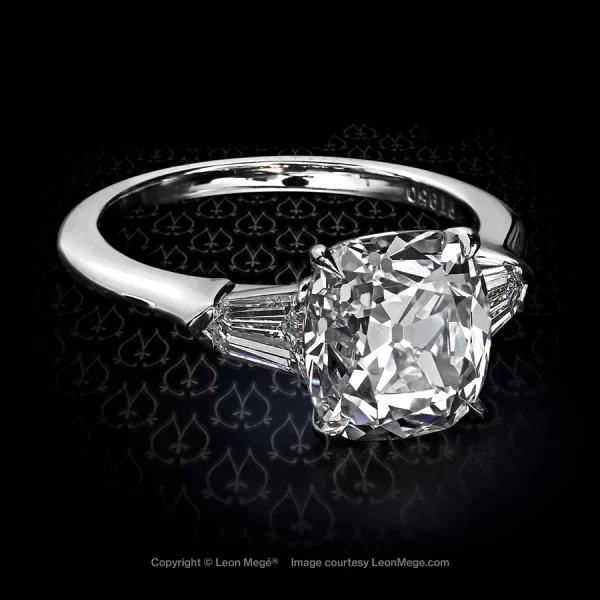 Three stones ring featuring a True Antique cushion diamond by Leon Mege.