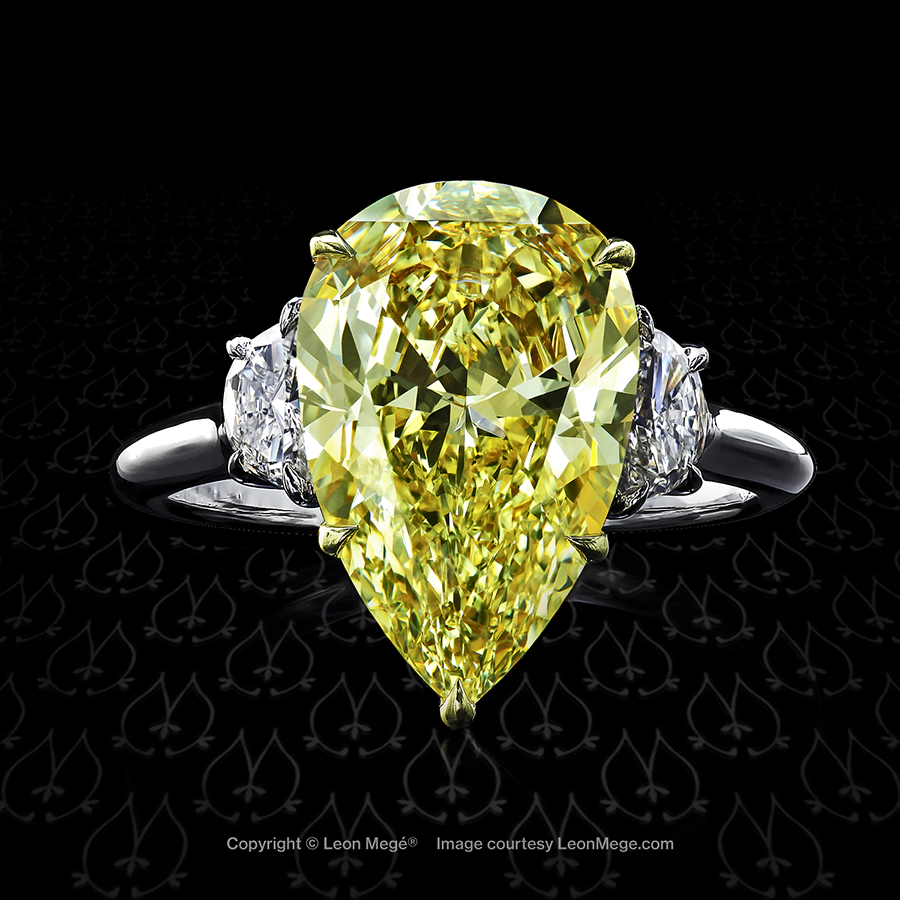 Three stones engagement ring featuring a fancy yellow pear shaped diamond by Leon Mege.