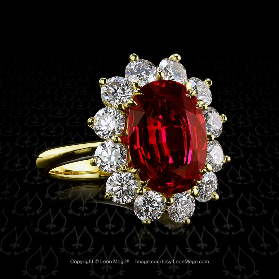 Cluster halo ring featuring a cushion cut ruby by Leon Mege.