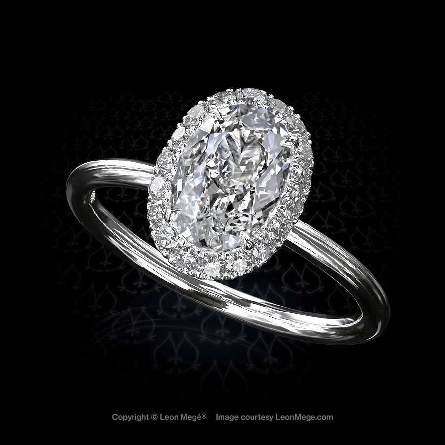 The lovable Leon Mege 810™ halo ring features an oval diamond embraced by a tender fuzz of crisp diamond pave r6916