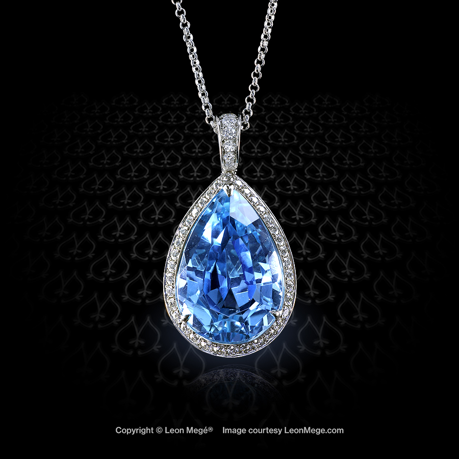 Custom made halo pendant featuring a pear shaped aquamarine by Leon Mege.