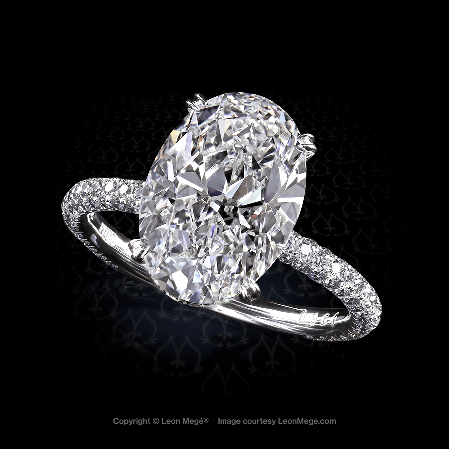 413 solitaire featuring an oval diamond by Leon Mege.