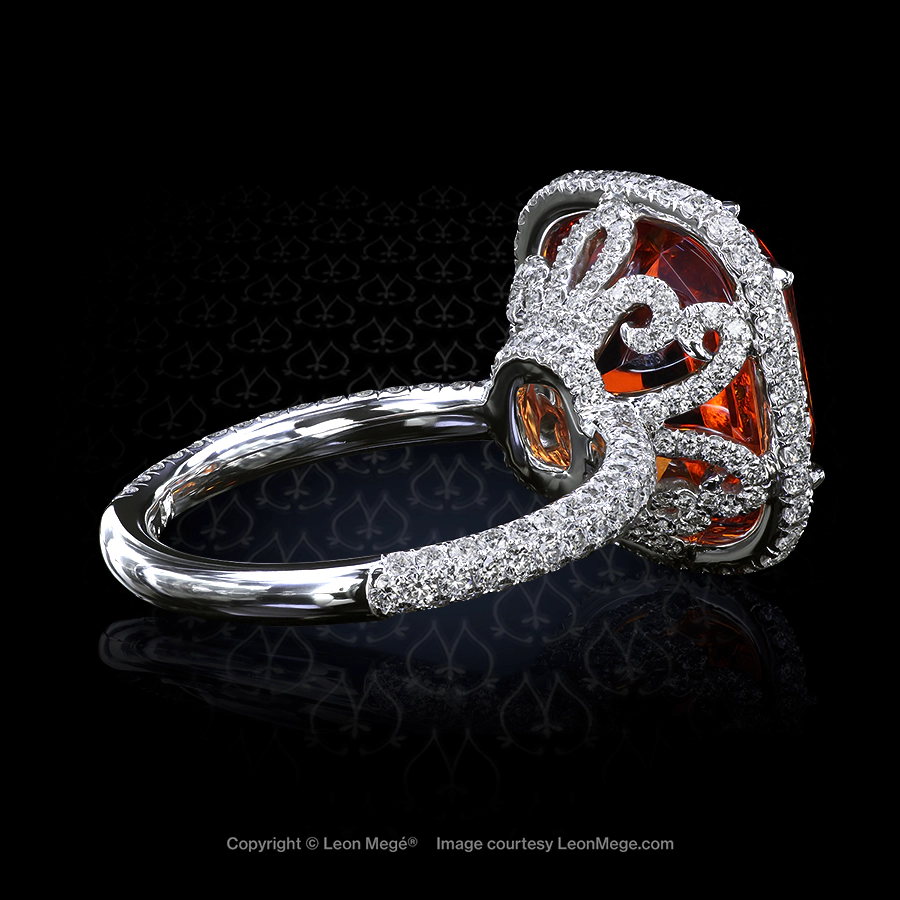 Custom made halo ring featuring a cushion orange garnet by Leon Mege.