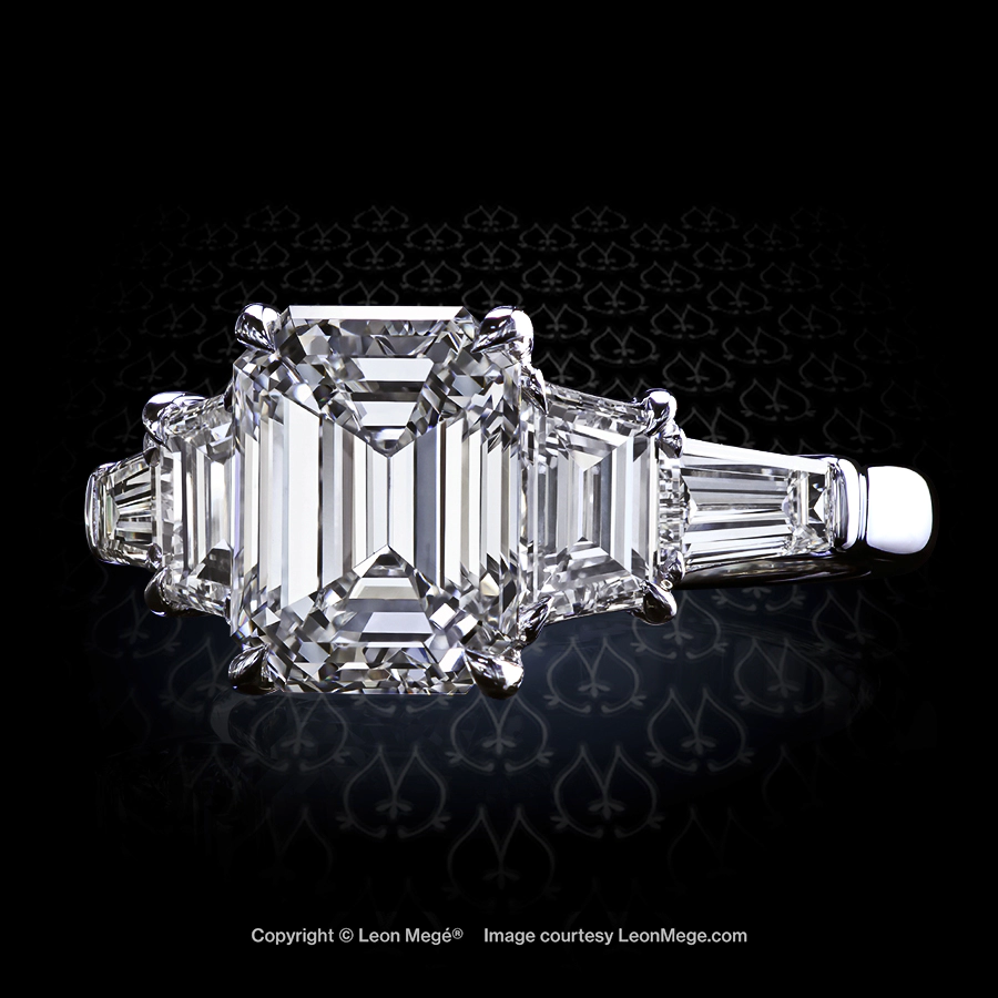Classic five-stone ring featuring an emerald cut diamond by Leon Mege.