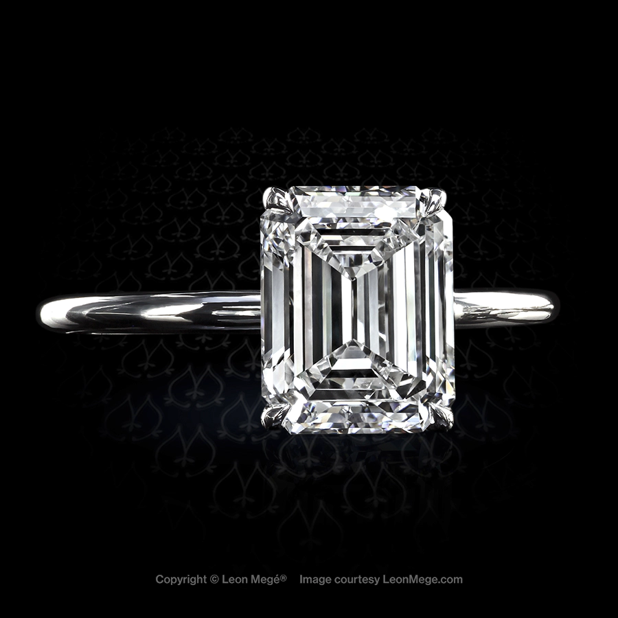 Modern solitaire featuring an emerald cut diamond by Leon Mege.