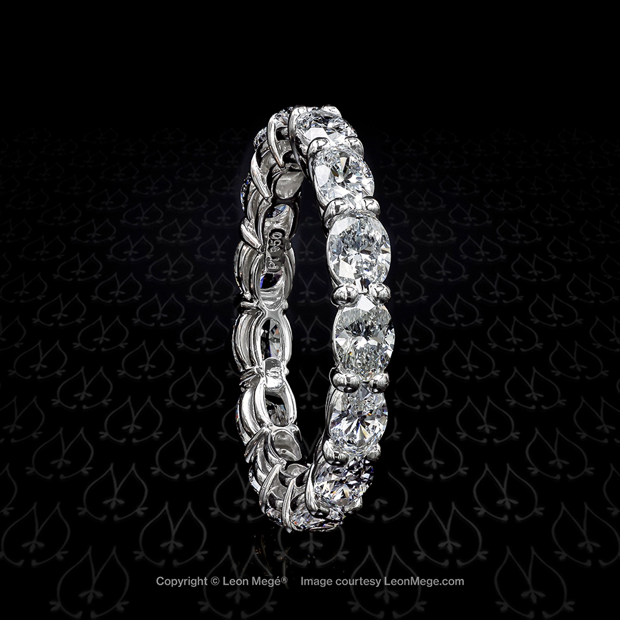 Shared prongs eternity wedding band with east-west set oval diamonds by Leon Mege.