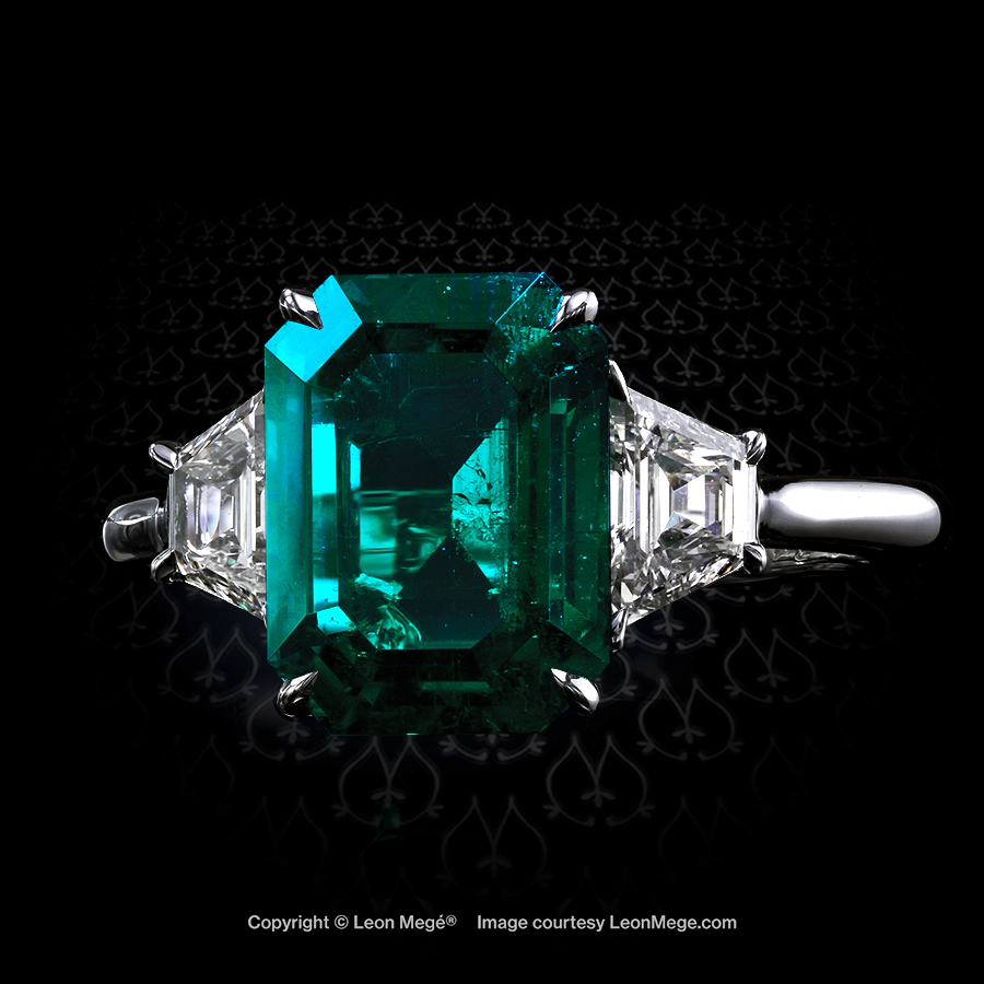 Classic three-stone ring featuring a natural Colombian emerald by Leon Mege.