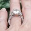 Leon Mege bespoke three-stone ring with a cushion diamond trapezoids and fleur-de-lis filigree r1221