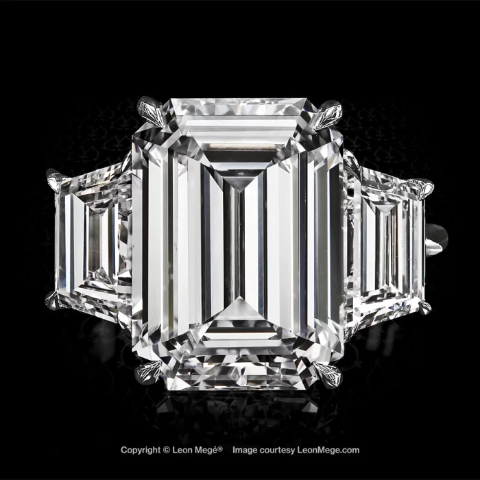 Three-stone platinum ring with 8ct emerald cut diamond and two step cut trapezoid diamonds by Leon Mege.