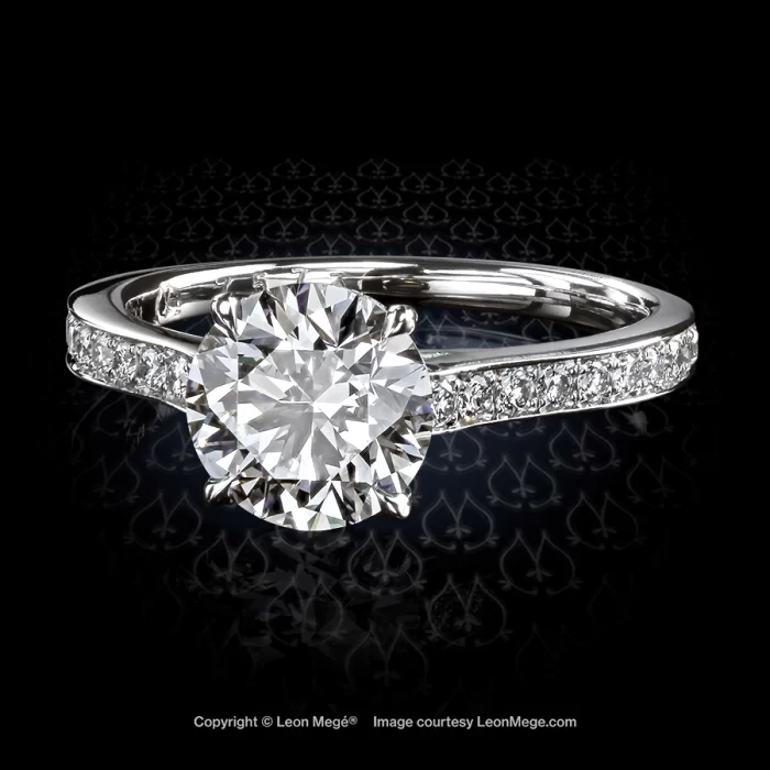 Custom made solitaire featuring a round diamond ring adorned with bright cut pave by Leon Mege.