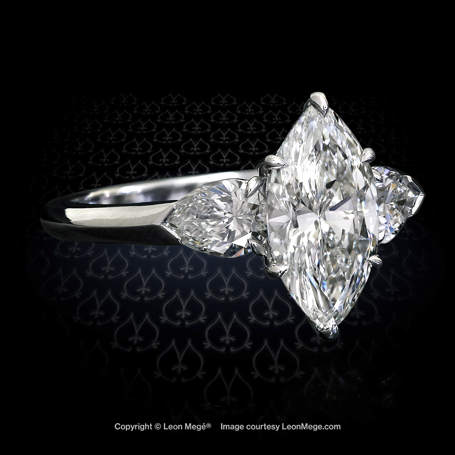 Classic three-stone ring featuring marquise diamond with pear shape diamonds by Leon Mege r1191