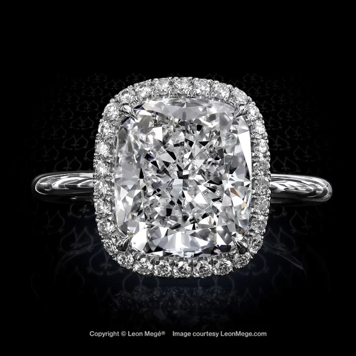 Stunning modern cushion diamond set in a micro pave halo with a thin shank by New York jeweler Leon Mege