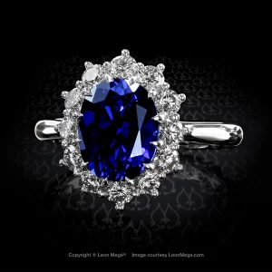Oval sapphire surrounded by white diamond cluster in hand made platinum setting by Leon Mege
