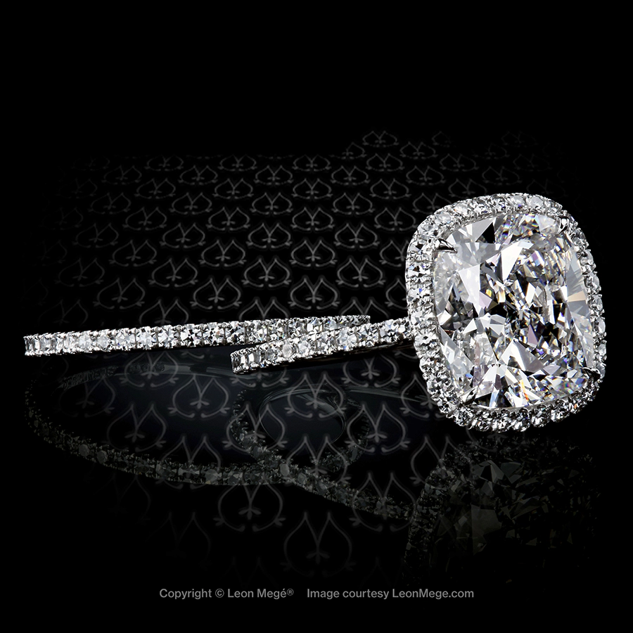 Diamond halo ring with modern cushion diamond set in platinum handmade ring custom designed by Leon Mege