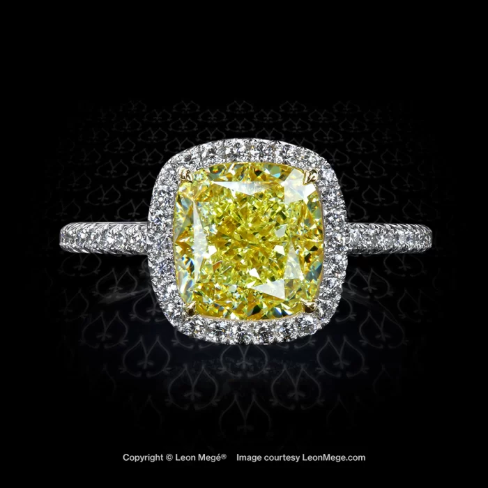 Engagement ring with fancy yellow cushion diamond and micro pave halo by Leon Mege
