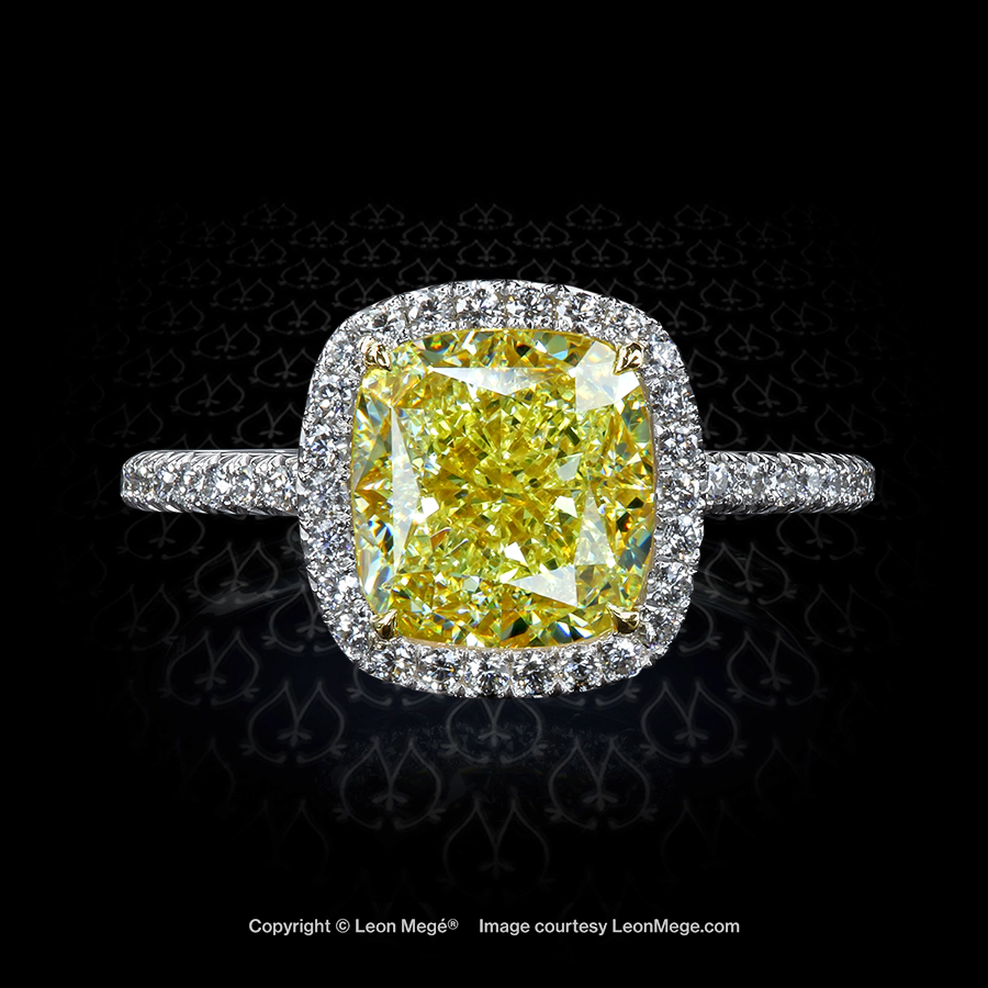 Engagement ring with fancy yellow cushion diamond and micro pave halo by Leon Mege