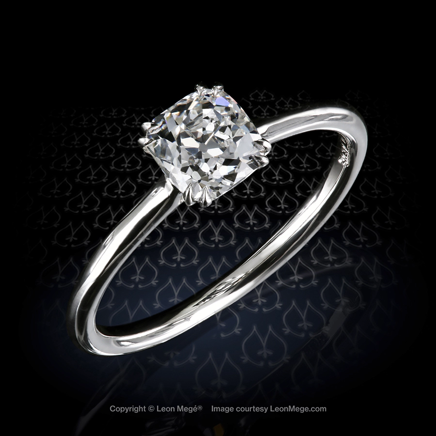 Elegant engagement ring featuring 0.83 carat antique cushion cut diamond set in platinum by Leon Mege