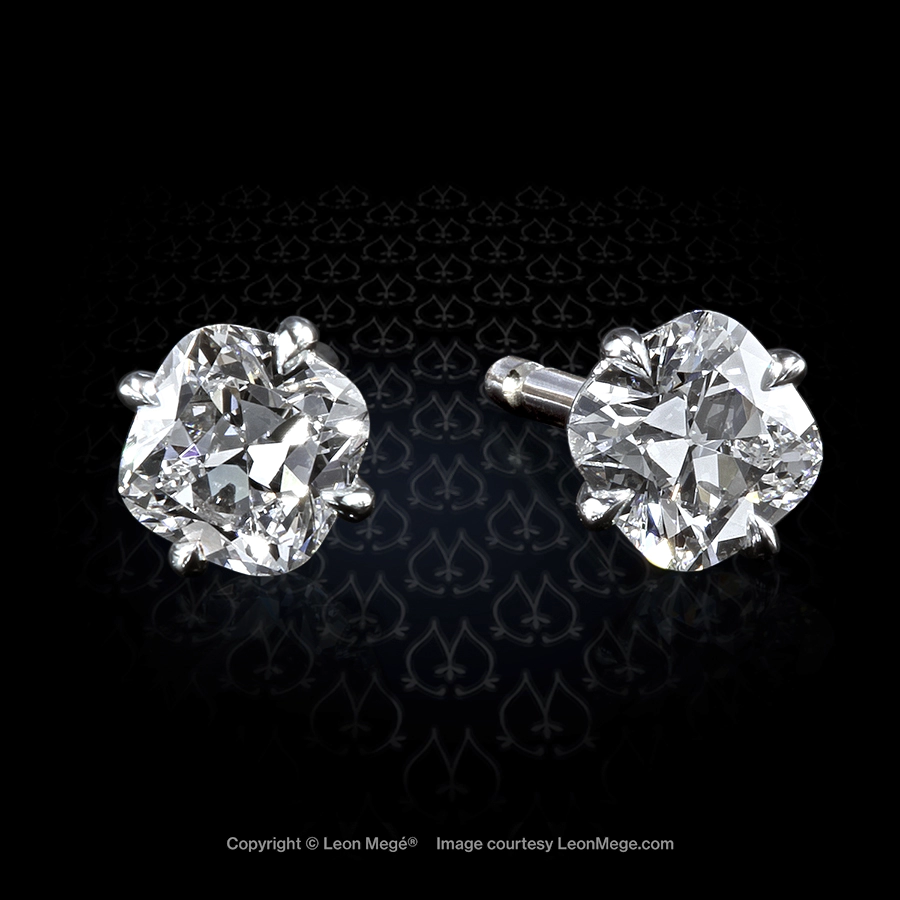 Hello Cutie™ diamond studs in platinum with four eagle claw prongs with 4 mm cushion diamonds by Leon Mege