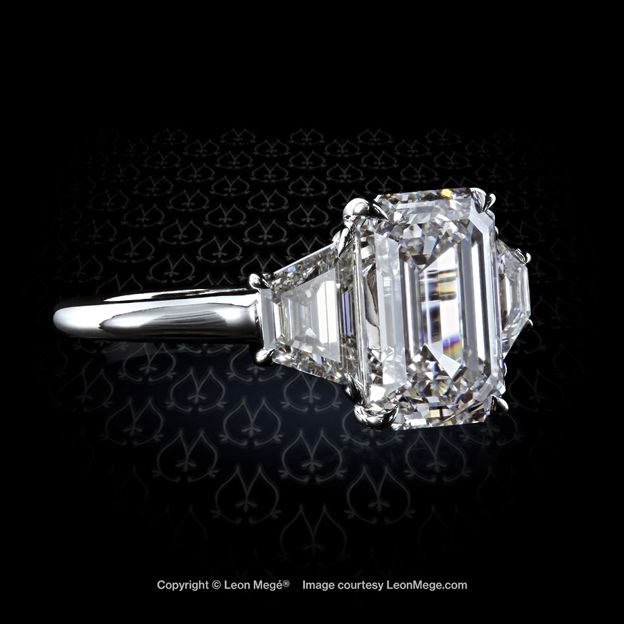 Classic three-stone engagement ring with 4.01 carat emerald cut diamond and diamond trapezoids by Leon Mege