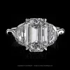 Three stone ring with emerald cut diamond and step cut half moon diamonds in a platinum setting by Leon Mege