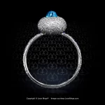 Leon Megé Brazilian Paraiba cab in a right-hand ring with sapphires on a micro pave shank r7777