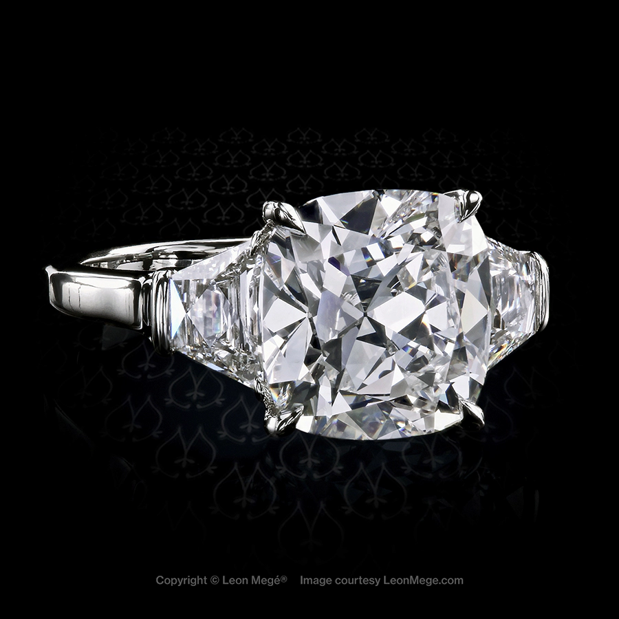 Classic three-stone ring with 5.02 carat Antique cushion diamond and french cut trapezoids in platinum by Leon Mege