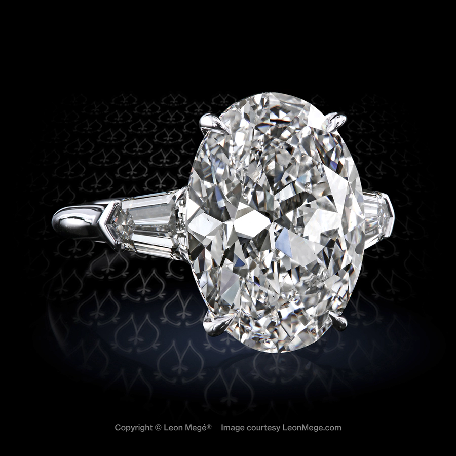 Classic three-stone ring featuring 7.51 carat oval diamond handmade by Leon Mege
