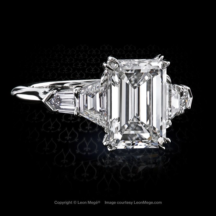 Classic five-stone ring, featuring 2.74 carat emerald diamond.