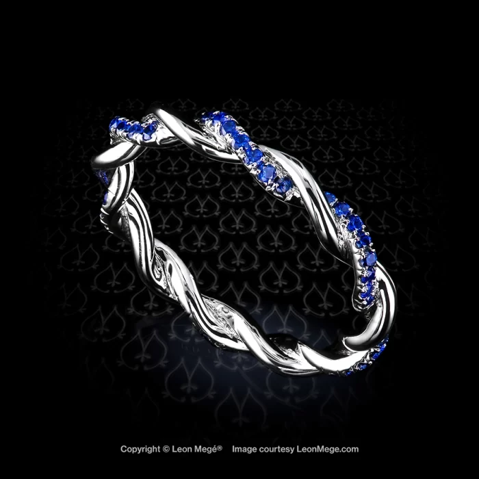 Pave set sapphire eternity twist ring featuring blue sapphires and white round diamonds by Leon Mege