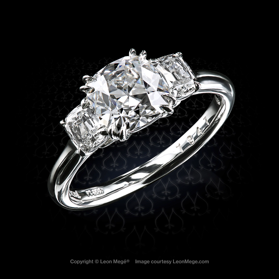 Classic three-stone ring with true antique™ cushion diamonds by Leon Mege