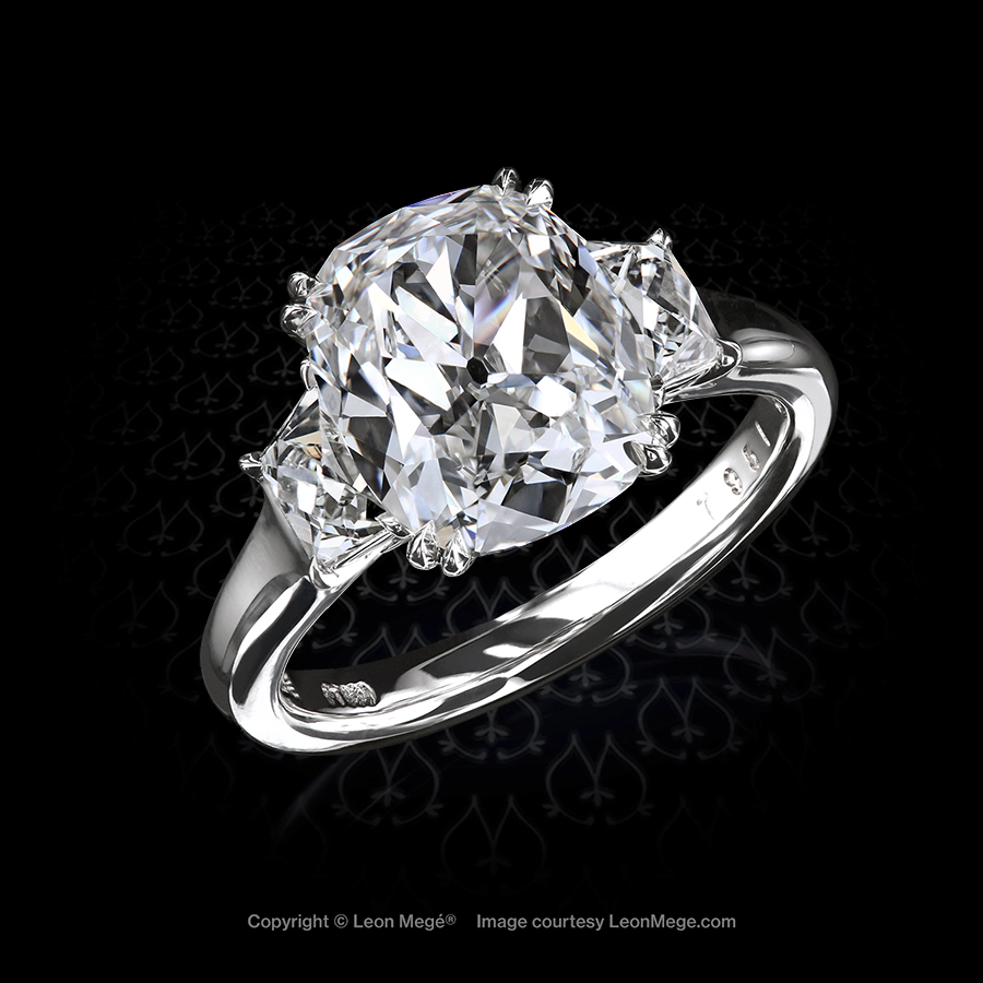 True antique cushion diamond set with a pair of French cut trapezoids in a platinum handmade ring by Leon Mege