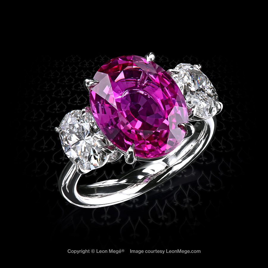 Three stone ring with natural 8-carat hot-pink sapphire and a pair of oval diamonds on its side hand-forged by Leon Mege
