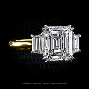 Double claw prongs holding the center stone in Leon Mege custom made three-stone ring with emerald cut diamond and two trapezoids.