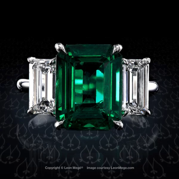Classic three-stone ring featuring 5.61ct emerald by Leon Mege