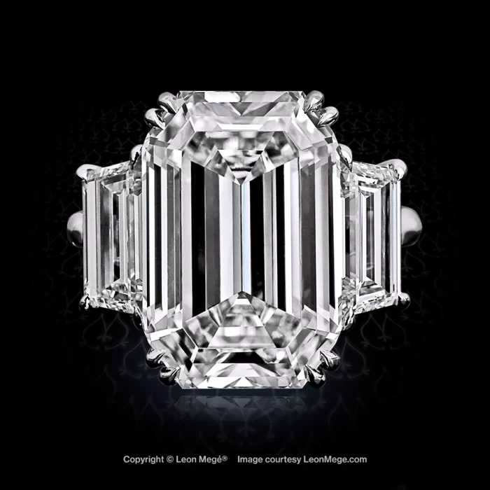 Emerald cut three stone ring with diamond trapezoids by Leon Mege