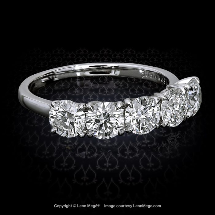 Custom-made band with five matching ideal cut diamonds in an elegant platinum mounting with single claw prongs r4152
