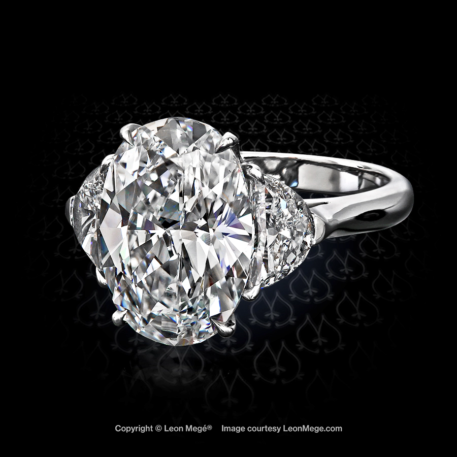 Leon Mege three tsone diamond ring with afive carat oval and half-moon diamond side-stones