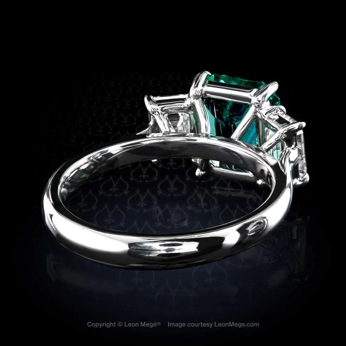 Three stone ring with emerald cut Colombian emerald and emerald cut diamond side stones