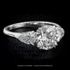 Leon Megé classic three-stone engagement ring precision-forged in platinum with a round diamond and pear-shape diamonds on the sides r5454
